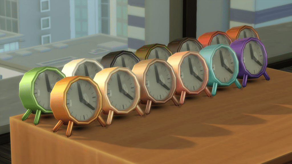 Multiple versions of an alarm clock, all different color swatches, lined up for display on a table.