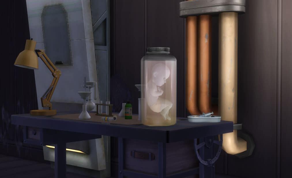 A desk in a darkly lit laboratory with various beakers, vials, trays, and pipes. The image is focused on a jar sitting on the desk that has an infant sim's body floating inside.